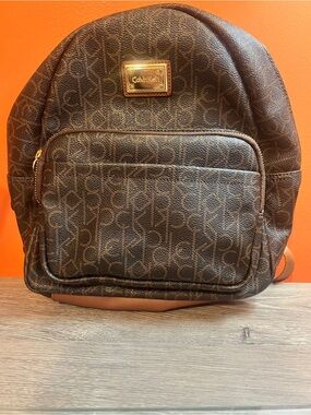 Calvin Klein Brown Monogram Mini Backpack with Gold Plaque